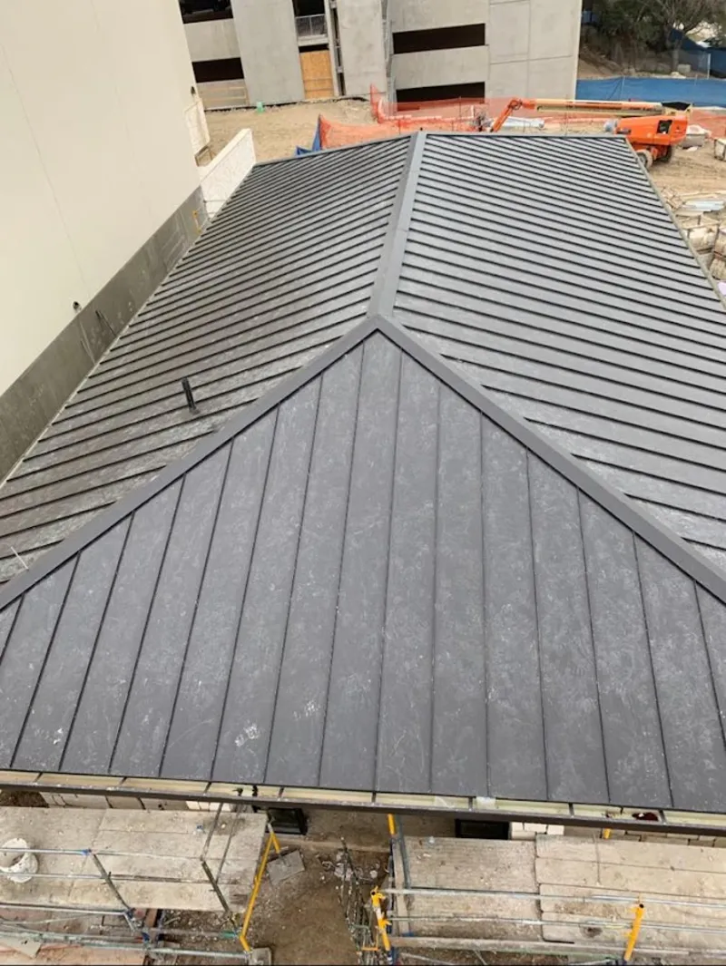 Commercial metal roof construction with crane equipment in Lake Geneva